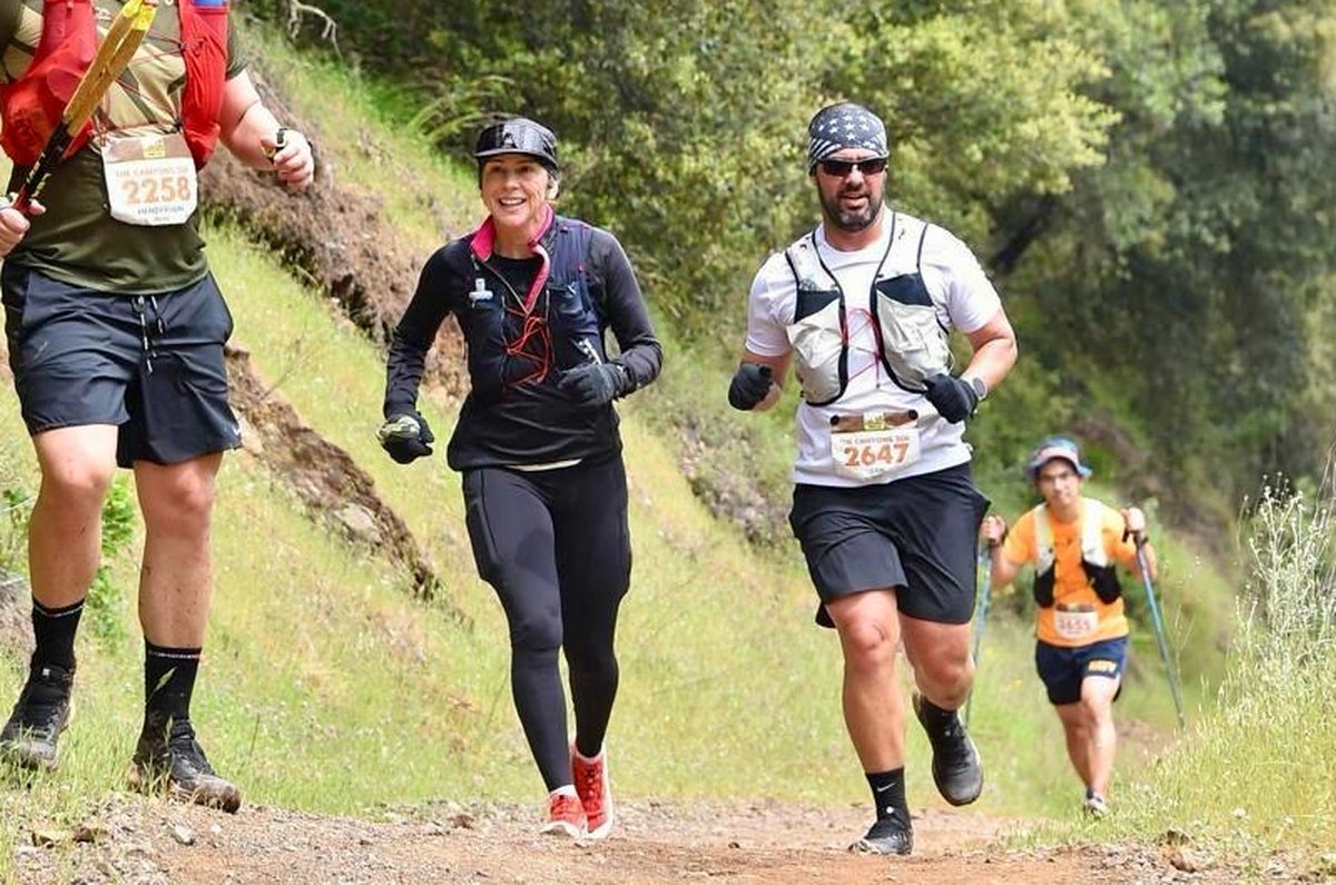 Atletas de CMTeam subiendo un sendero de tierra en una carrera de trail